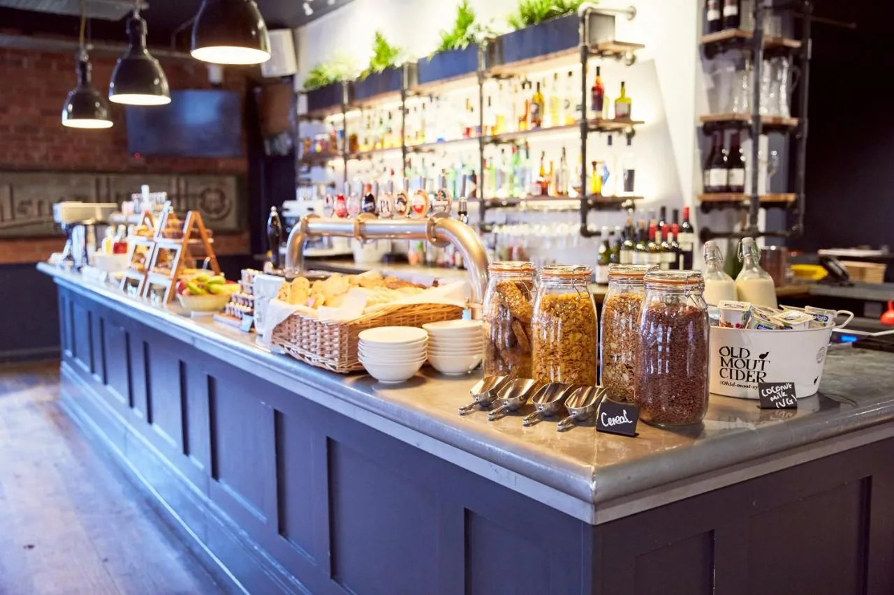 A bar with a counter with jars of food at Frederick Street Townhouse in Birmingham