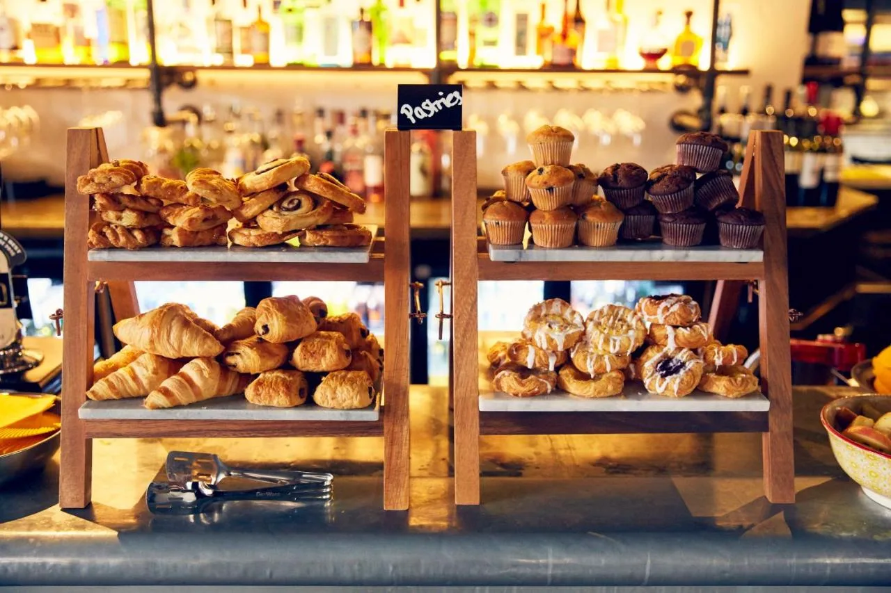 Two shelves with different types of bread and pastries at Frederick Street Townhouse in Birmingham